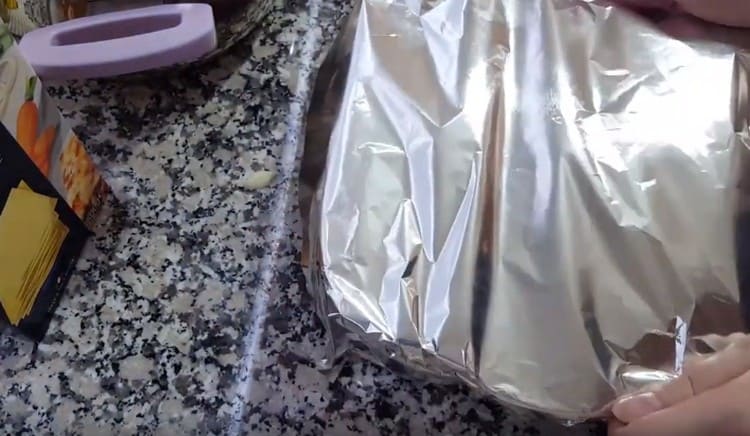 Cover the form with foil and put in the oven.