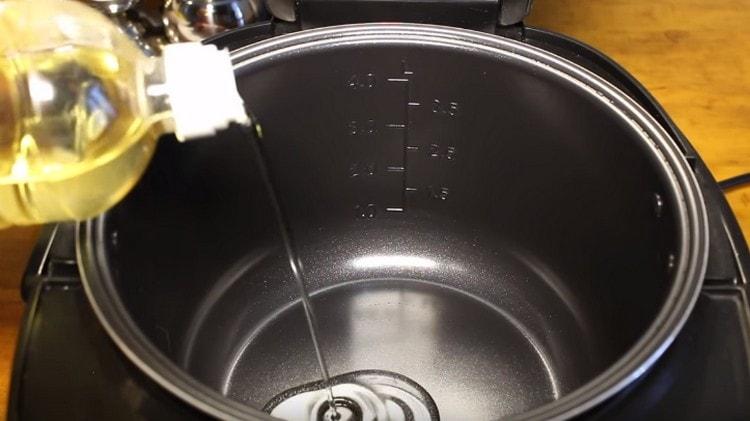Pour vegetable oil into the multicooker bowl.
