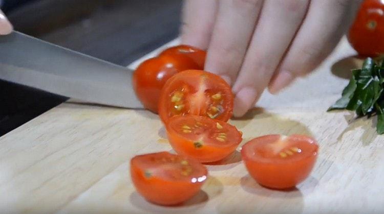 Halve the cherry tomatoes.