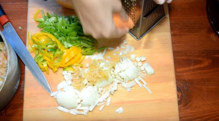 Grind vegetables for the sauce: onions, carrots, peppers, garlic.