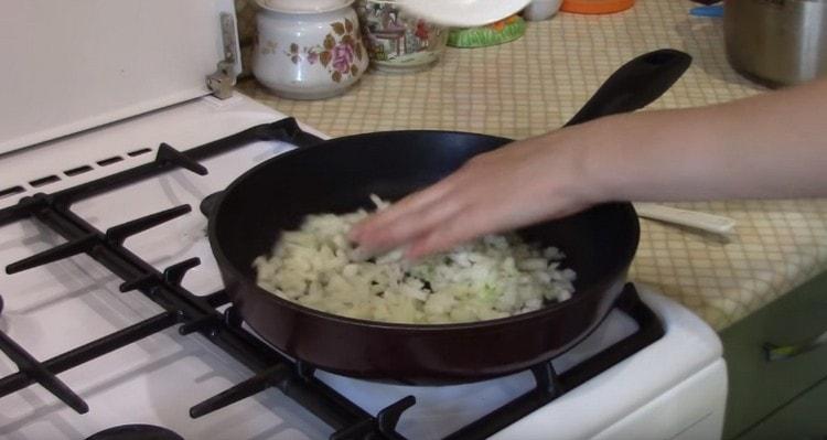 First, fry the onion with garlic in a pan.