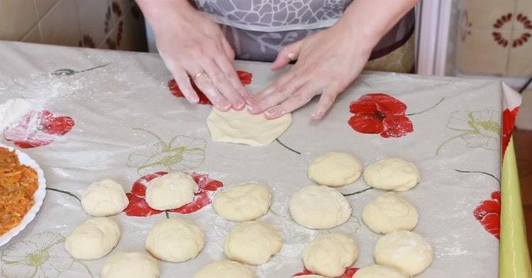 Knead the dough into flat cakes.