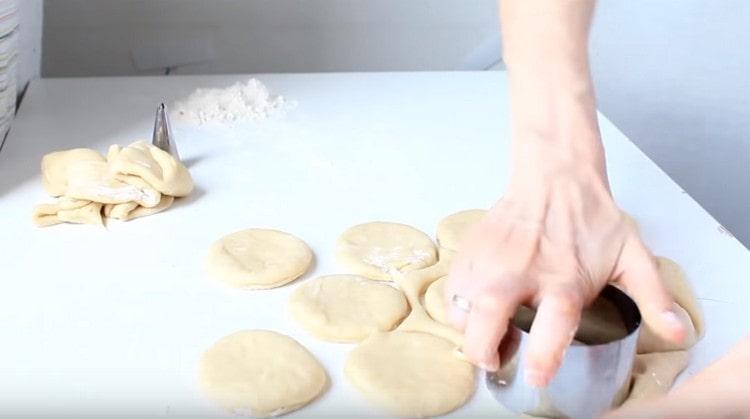 Using a mold, squeeze out round donuts.