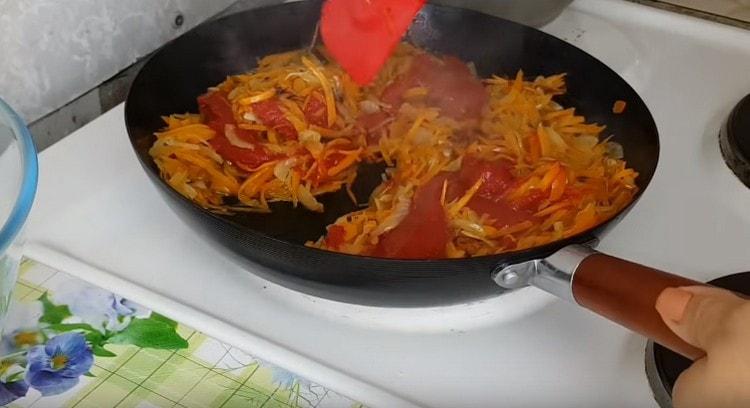 Add tomato paste to the vegetables.