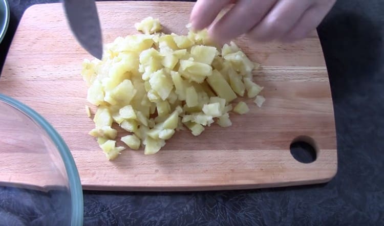 Dice boiled potatoes and carrots.