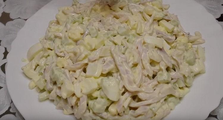 Habillez la salade de calmars avec le concombre et l'oeuf avec la mayonnaise, mélangez et servez.