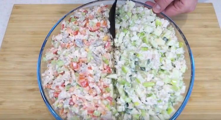 With a spoon we make a small groove between two types of salad.