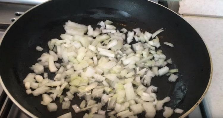 Separately, fry the onions in a pan until soft.