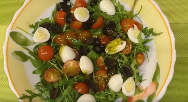 Ajouter les œufs, les olives, les tomates et la vinaigrette à la roquette.