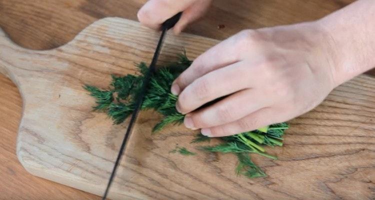 We chop dill with a knife.