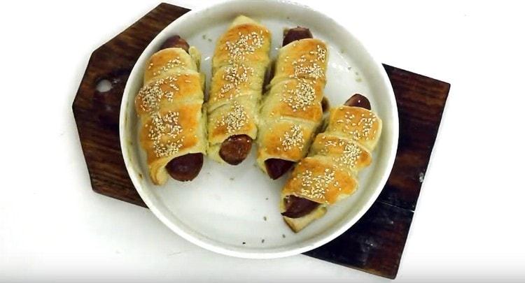 Appetizing sausages in a puff pastry dough ready.