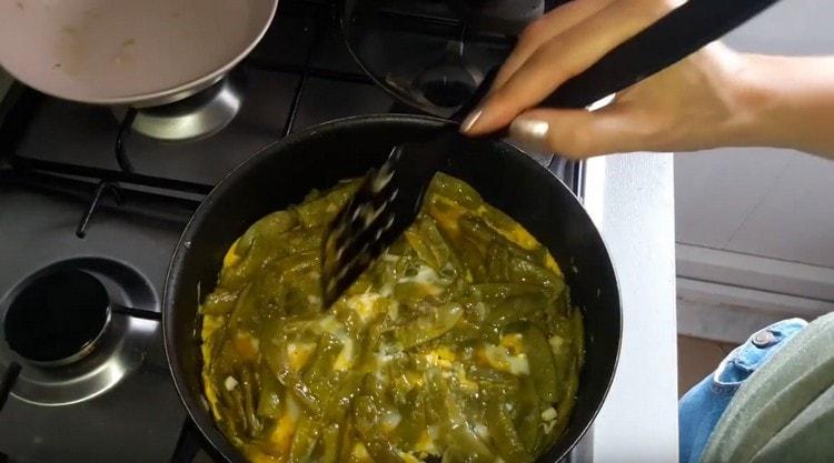 Versez les œufs dans la casserole jusqu'aux haricots, mélangez.