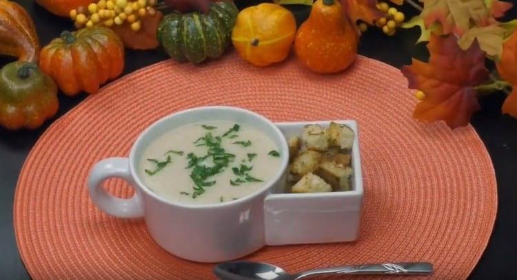 Appetizing celery puree soup served with crackers.