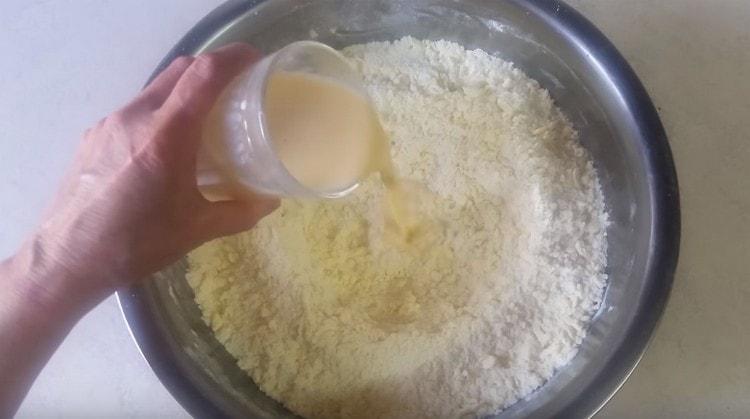 We introduce the liquid components to the butter and flour crumbs.