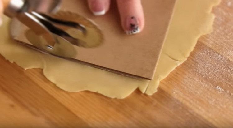 Using a template, we cut out sheets for lasagna.