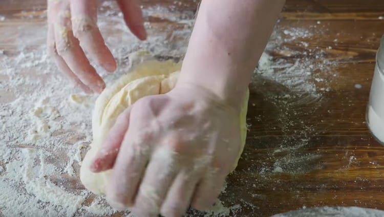 Then carefully knead the dough on the table.