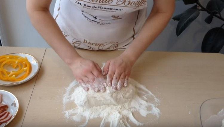 Gently roll the dough in flour.