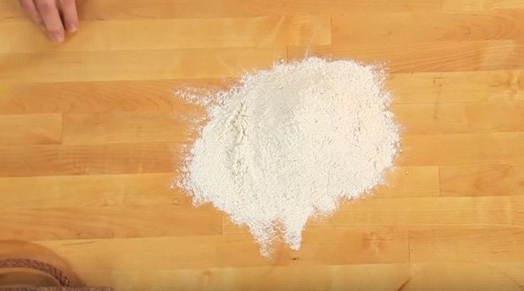 Sift flour onto the work surface.