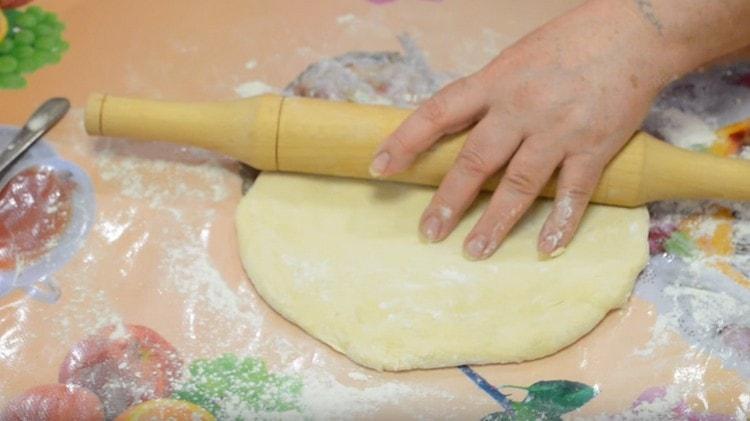 Roll out the dough with a rolling pin.