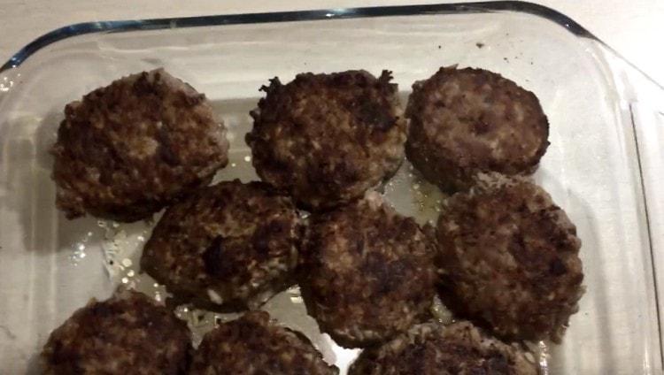 Next, we shift the fried meatballs into a baking dish.