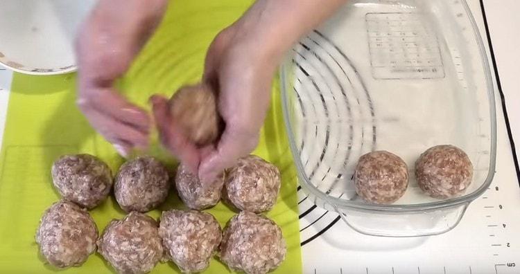 À partir des portions obtenues, nous formons des boulettes de viande rondes et les mettons en forme.