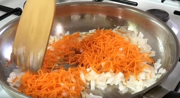 Add the grated carrots to the soft onion in the pan.