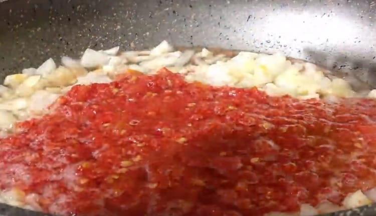 Add tomato sauce to the onion with garlic.