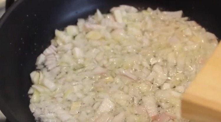 Separately, fry the onions in a pan until soft.