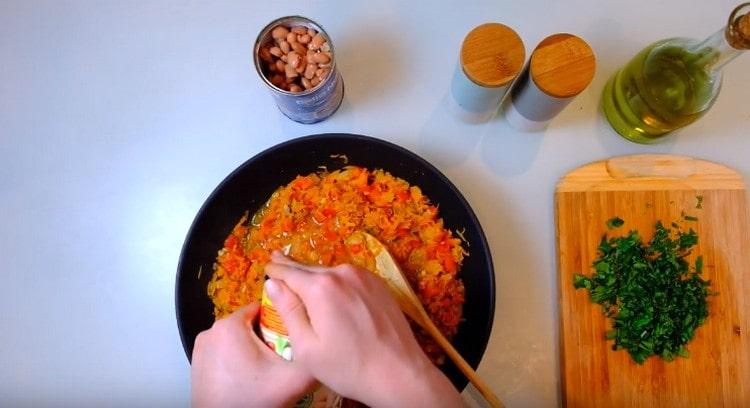 Pour the liquid from the canned beans into the pan.