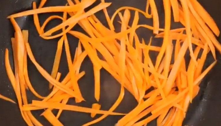 Separately, fry carrots chopped into thin strips.