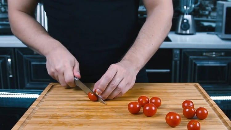 Cut the cherry tomatoes in half.