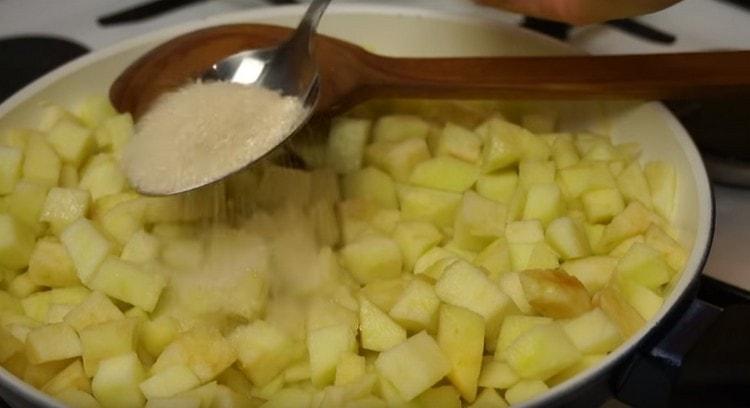 Add apples to the pan, and then sugar.