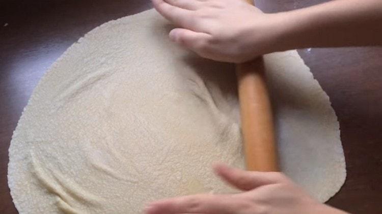 Roll out the dough as thin as possible.