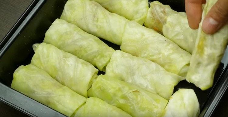 Spread cabbage rolls in a baking dish.