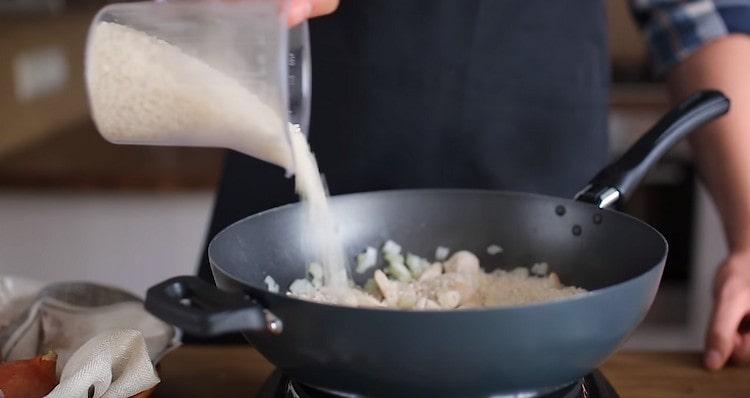 Add garlic and washed rice.