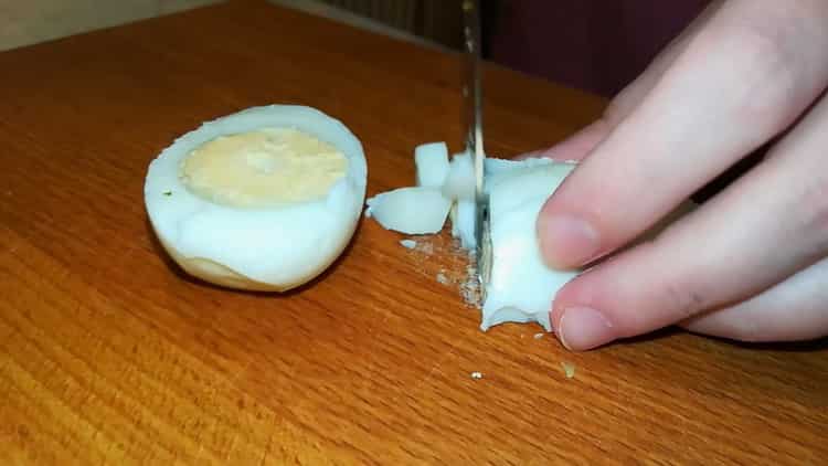 Cut eggs to make a salad