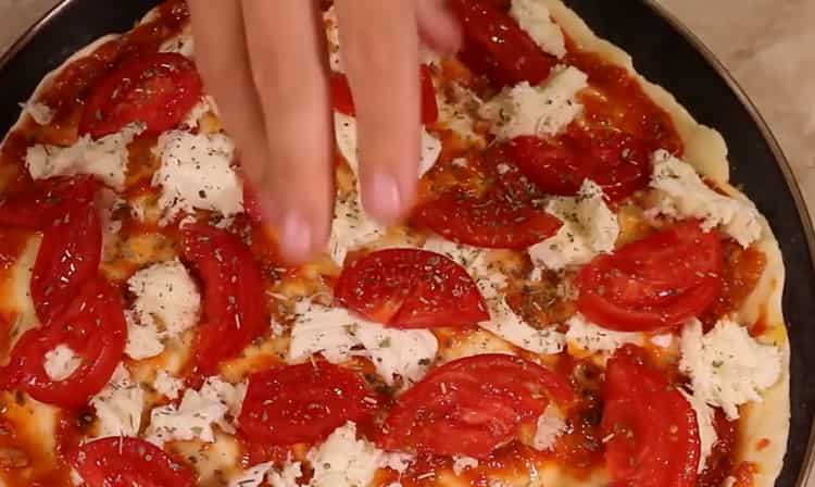 To prepare pizza on the dough, lay the filling