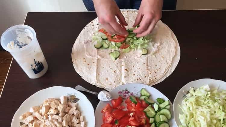 Για να προετοιμάσετε ένα κλασικό shawarma, βάλτε το γέμισμα στο ψωμί pita