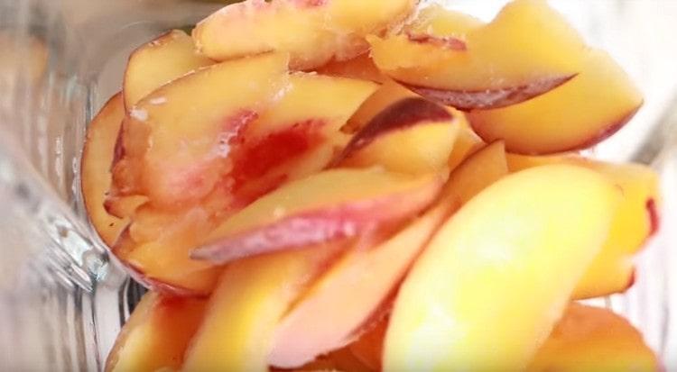 Frozen peaches in a blender bowl.
