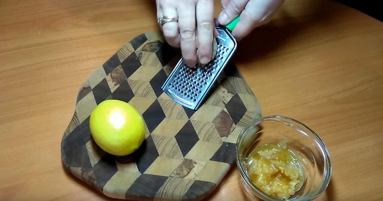 We rub a piece of ginger root on a grater.