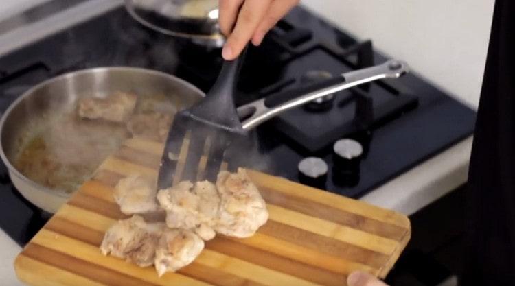 Fry the chicken in a pan until cooked.