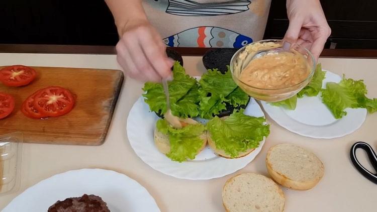 Para hacer hamburguesas, engrase un pan con salsa