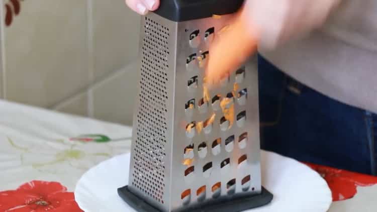 Grate carrots to make soup