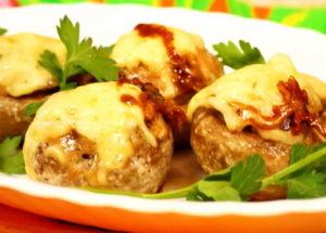mushrooms stuffed with chicken and cheese in the oven