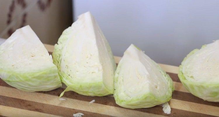Cut the head of cabbage into 4 parts.