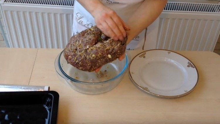 Hand remove excess marinade from the pickled meat.