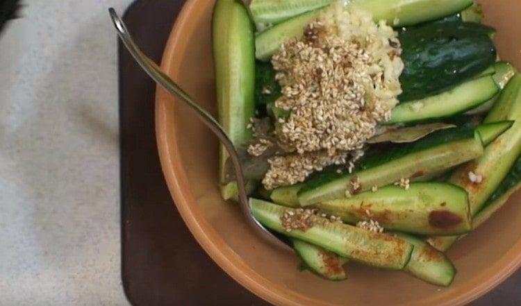 Add the fried sesame seeds to the cucumbers.