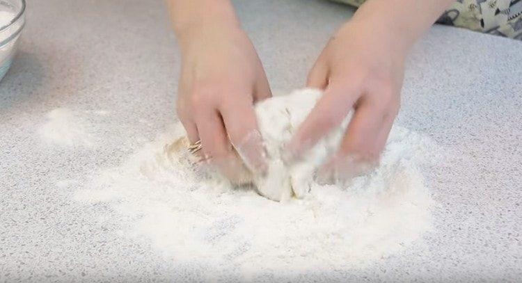 We knead the dough with flour.