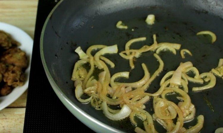 Fry the onion in a pan until golden brown.