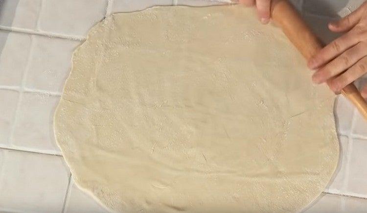 Roll out the dough with a rolling pin.